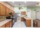 Bright kitchen featuring wood cabinetry, stainless steel appliances, and an open floor plan to the connecting room at 3140 N 114Th Dr, Avondale, AZ 85392