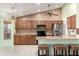 Well-equipped kitchen featuring wood cabinetry, modern appliances, and a functional layout at 3140 N 114Th Dr, Avondale, AZ 85392
