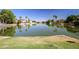 Expansive lake view with surrounding homes and lush greenery provides a serene atmosphere at 3140 N 114Th Dr, Avondale, AZ 85392