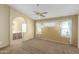 Bright primary bedroom showcasing an ensuite bathroom, natural light, and a comfortable carpeted floor at 3140 N 114Th Dr, Avondale, AZ 85392