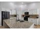 Spacious kitchen featuring an island with granite countertops and stainless steel appliances at 3592 E Sandwick Dr, San Tan Valley, AZ 85140