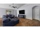 Spacious living room with a vaulted ceiling, tile floors and a comfortable sectional sofa at 3592 E Sandwick Dr, San Tan Valley, AZ 85140