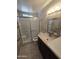 Bright bathroom with shower, frosted glass, and modern vanity mirror at 3621 N 65Th Ave, Phoenix, AZ 85033