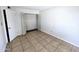 Bright bedroom featuring tiled floors, a spacious closet, and neutral walls at 3621 N 65Th Ave, Phoenix, AZ 85033