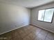 Clean, empty bedroom with neutral walls, tiled floor, and a bright window at 3621 N 65Th Ave, Phoenix, AZ 85033