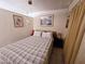 Cozy bedroom featuring a comfortable bed with a plaid patterned bedspread and a window at 3621 N 65Th Ave, Phoenix, AZ 85033