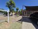 Single-story home with xeriscaped front yard, mature trees, and covered parking at 3621 N 65Th Ave, Phoenix, AZ 85033