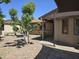 Home's exterior with a xeriscaped yard, mature trees, and covered walkway at 3621 N 65Th Ave, Phoenix, AZ 85033