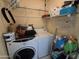 Functional laundry area features washer, dryer, and overhead storage shelves at 3621 N 65Th Ave, Phoenix, AZ 85033