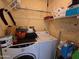 Functional laundry area features washer, dryer, and overhead storage shelves at 3621 N 65Th Ave, Phoenix, AZ 85033