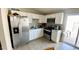 Bright kitchen features white cabinets, stainless steel appliances, and tile flooring at 3645 N 71St Ave # 28, Phoenix, AZ 85033