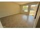 View of the living room showcasing neutral walls and tile flooring creating a bright and airy space at 3645 N 71St Ave # 28, Phoenix, AZ 85033
