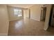 Inviting living room featuring neutral walls, tile floors, and a large window for natural light at 3645 N 71St Ave # 28, Phoenix, AZ 85033