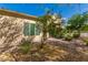 Inviting backyard featuring desert landscaping, including mature trees, shrubs, and a patio visible through the rear window at 3910 N 163Rd Dr, Goodyear, AZ 85395