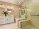 Elegant bathroom boasts a double vanity, glass-enclosed shower, and soaking tub for a luxurious experience at 3910 N 163Rd Dr, Goodyear, AZ 85395