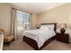 Cozy bedroom featuring a queen bed, plantation shutters, and neutral decor at 3910 N 163Rd Dr, Goodyear, AZ 85395