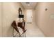 Inviting hallway features tiled floors, decorative mirror, accent chair and stylish decor elements at 3910 N 163Rd Dr, Goodyear, AZ 85395
