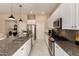 Bright kitchen with stainless steel appliances, granite counters, and a central island at 3910 N 163Rd Dr, Goodyear, AZ 85395