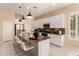 Spacious kitchen with white cabinets, stainless steel appliances, and an island with bar seating at 3910 N 163Rd Dr, Goodyear, AZ 85395
