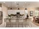 Elegant kitchen with white cabinets, granite counters, and pendant lighting above island seating at 3910 N 163Rd Dr, Goodyear, AZ 85395