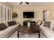 Bright living room featuring neutral tones, plantation shutters, and comfortable seating arrangements at 3910 N 163Rd Dr, Goodyear, AZ 85395