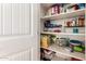 Organized pantry with shelving full of food and household items at 3910 N 163Rd Dr, Goodyear, AZ 85395
