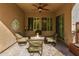 Charming covered patio featuring a comfortable seating area and outdoor decor at 3910 N 163Rd Dr, Goodyear, AZ 85395