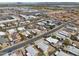 A diverse neighborhood is captured with various rooftops, tree-lined streets, and distant mountain views in an aerial shot at 3925 E Arbor Ave, Mesa, AZ 85206