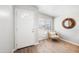 Cozy entryway featuring hardwood floors, chair, and a round decorative mirror at 3925 E Arbor Ave, Mesa, AZ 85206