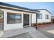Charming home exterior with a black door and windows, and updated landscaping at 3925 E Arbor Ave, Mesa, AZ 85206