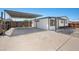 Exterior view of the property with a covered carport, driveway, and landscaping at 3925 E Arbor Ave, Mesa, AZ 85206