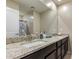 Bathroom featuring a double sink vanity with granite countertop, dark wood cabinets, and modern fixtures at 3929 S 79Th Ln, Phoenix, AZ 85043