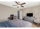 A well-lit bedroom features a ceiling fan, a neutral color scheme, and ample space for a desk setup at 3929 S 79Th Ln, Phoenix, AZ 85043