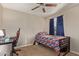 Cozy bedroom with natural light, ceiling fan, a desk and comfy chair setup, and sports-themed bed at 3929 S 79Th Ln, Phoenix, AZ 85043