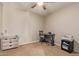 This carpeted bedroom features a ceiling fan, neutral walls, and desk area for quiet work at 3929 S 79Th Ln, Phoenix, AZ 85043