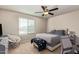 Comfortable bedroom featuring a ceiling fan, neutral walls, and a cozy seating area by the window at 3929 S 79Th Ln, Phoenix, AZ 85043