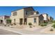 Beige two story home with a brown tiled roof, landscaped front yard, and concrete walkway with front door at 3929 S 79Th Ln, Phoenix, AZ 85043