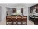 Elegant kitchen with dark cabinetry, granite countertops, a central island with seating, and modern stainless steel appliances at 3929 S 79Th Ln, Phoenix, AZ 85043
