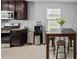 Well-equipped kitchen with dark wood cabinets, stainless steel appliances, tile flooring, and a dining area with seating at 3929 S 79Th Ln, Phoenix, AZ 85043
