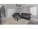 Contemporary living room featuring neutral gray walls, tile flooring, comfortable seating and a ceiling fan at 3929 S 79Th Ln, Phoenix, AZ 85043