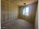 Bedroom showcases unfinished walls and a window providing natural light, awaiting finishing touches at 4344 E Brook Lynn Pl, San Tan Valley, AZ 85140