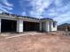 New home shows open garage and front porch, in the middle of the construction phase with insulation at 4344 E Brook Lynn Pl, San Tan Valley, AZ 85140