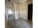 Hallway view showcasing unfinished walls and ceiling, leading towards sliding glass doors to the backyard at 4344 E Brook Lynn Pl, San Tan Valley, AZ 85140