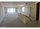 Living room with unfinished walls featuring sliding glass doors offering potential for design and natural light at 4344 E Brook Lynn Pl, San Tan Valley, AZ 85140