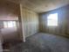 Spacious living area with unfinished walls, large windows and sliding door offering potential for customization at 4344 E Brook Lynn Pl, San Tan Valley, AZ 85140