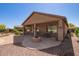 Backyard featuring desert landscape, covered patio and fire pit at 464 W Bismark St, San Tan Valley, AZ 85143
