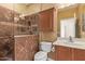 Bathroom featuring a tiled shower with a glass door, a toilet, a vanity, and an overhead light at 464 W Bismark St, San Tan Valley, AZ 85143