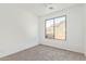 This carpeted bedroom features a ceiling fan and a window offering natural light at 464 W Bismark St, San Tan Valley, AZ 85143