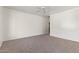 Expansive bedroom with neutral carpet and ceiling fan offers space and comfort at 464 W Bismark St, San Tan Valley, AZ 85143