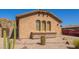 Single-story home showcasing desert landscaping, a stucco exterior, and a red disposal container at 464 W Bismark St, San Tan Valley, AZ 85143